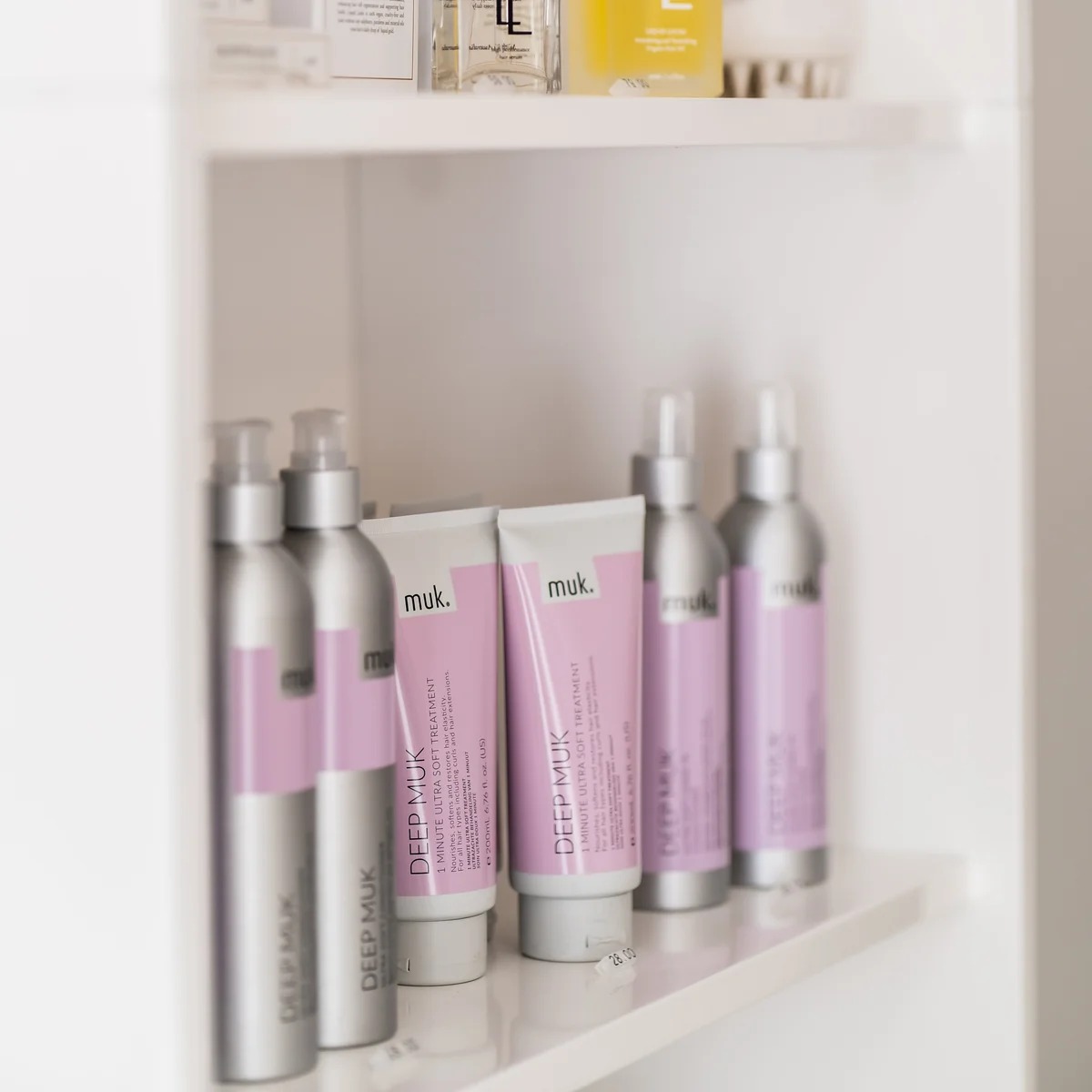 Hair extension aftercare products on a salon shelf